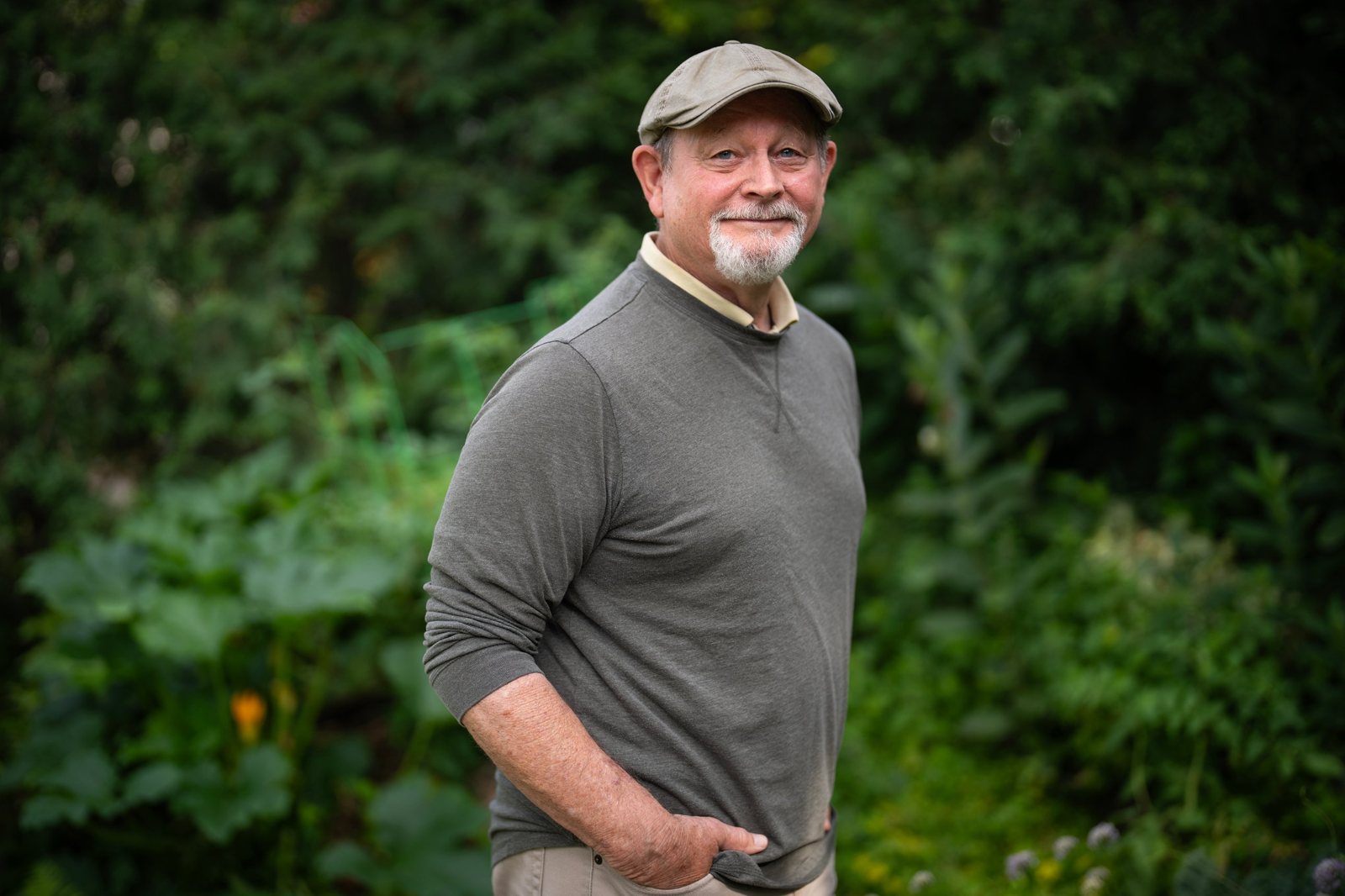 Author William Kent Krueger standing in a garden
