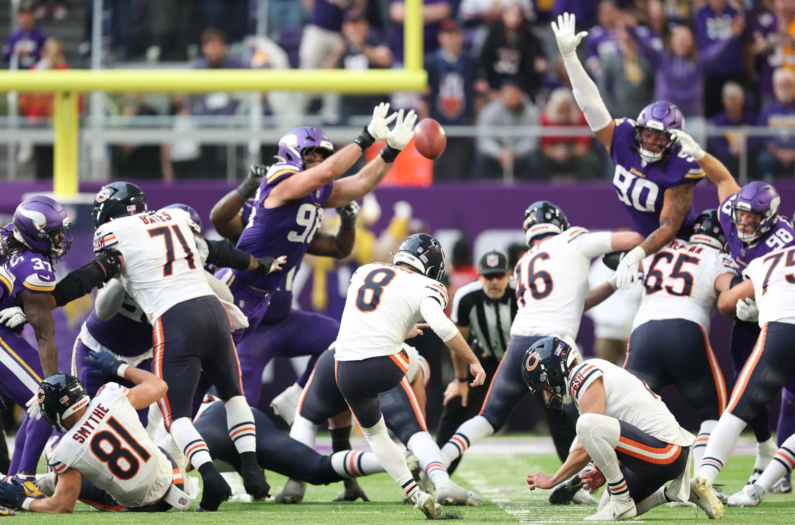 Vikings defenders leap to block a Chicago Bears field goal at U.S. Bank Stadium
